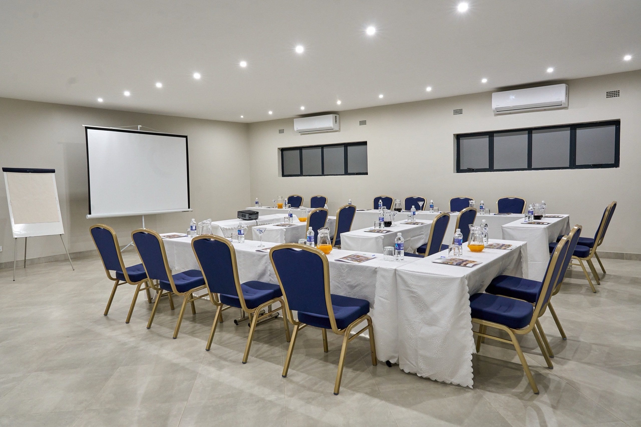 Conference room with projector screen and flip chart