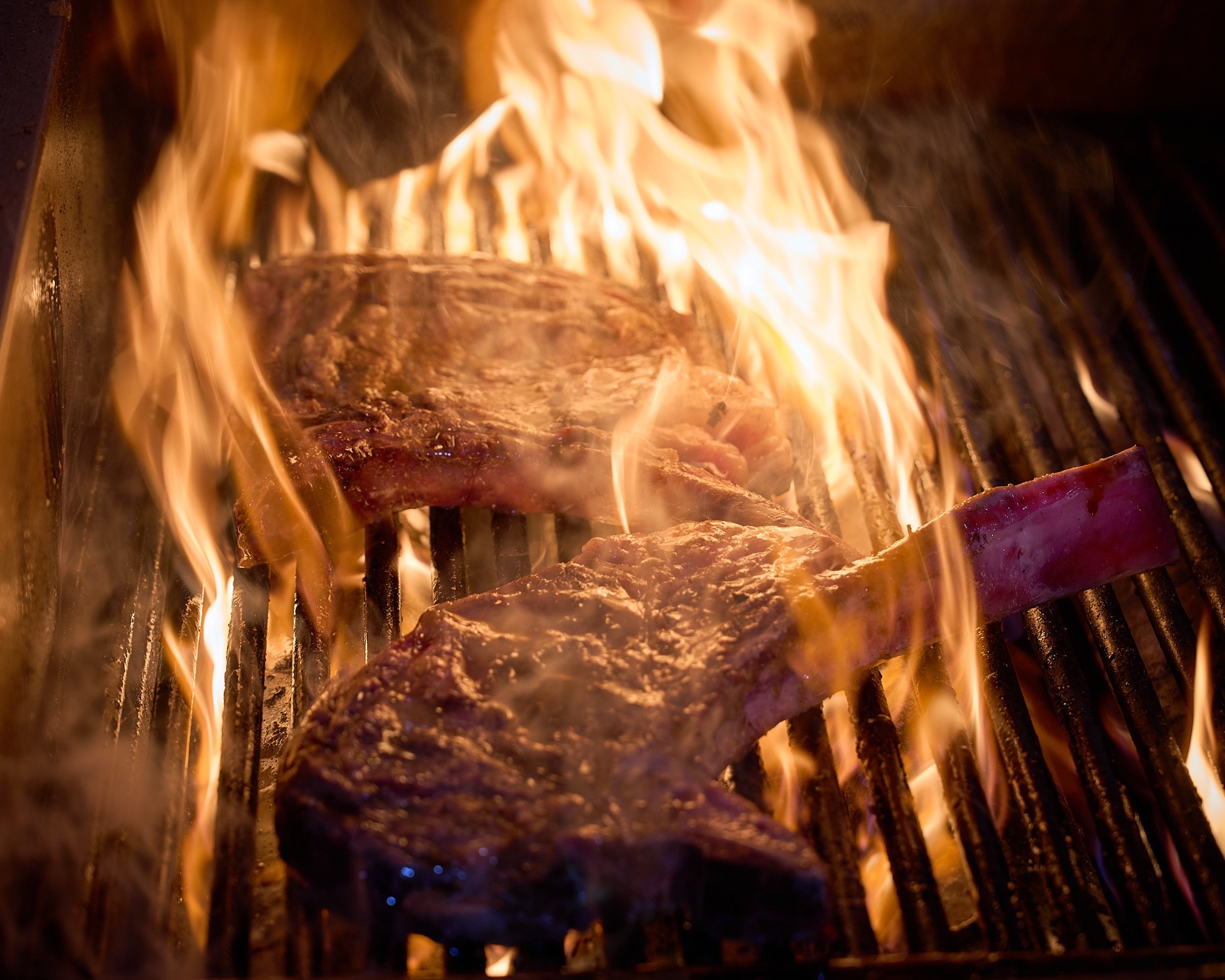 Steaks searing on the grill